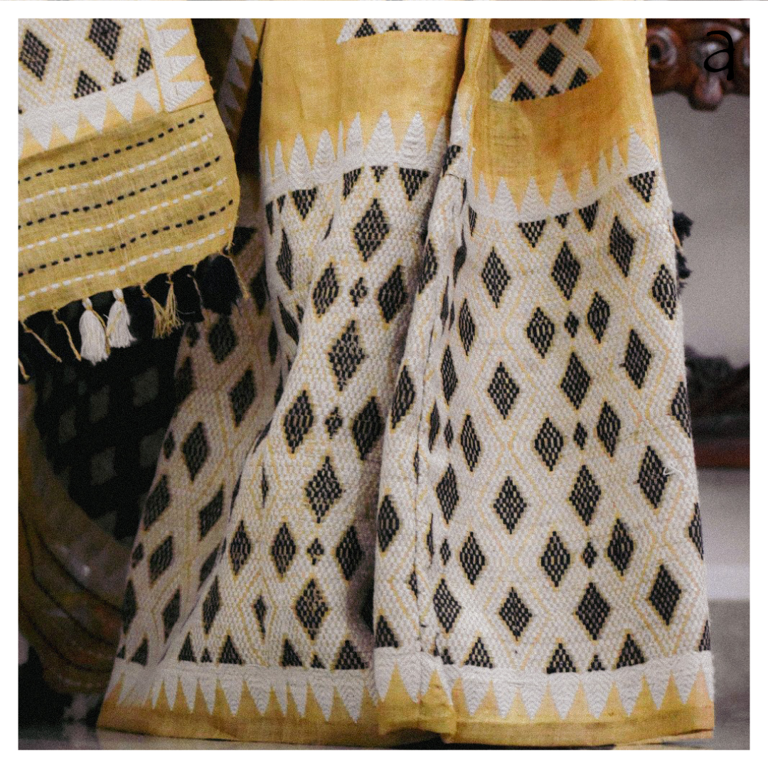 Muga silk mekhela chador with naturally dyed eri silk motifs, handcrafted in Guwahati.